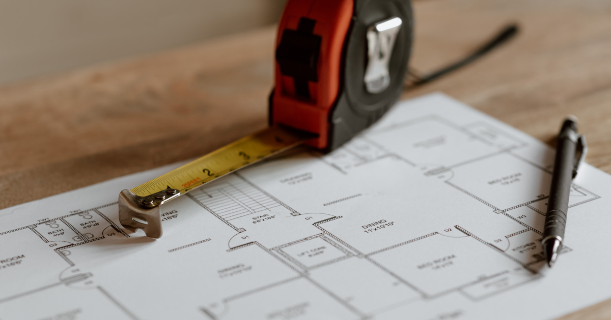 Floor plan diagram with tape measure and pen