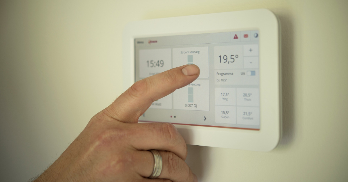 Person using a smart thermostat